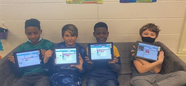 Student with iPads coding